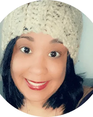 Shaina Buckner, smiling, wearing a knit hat.